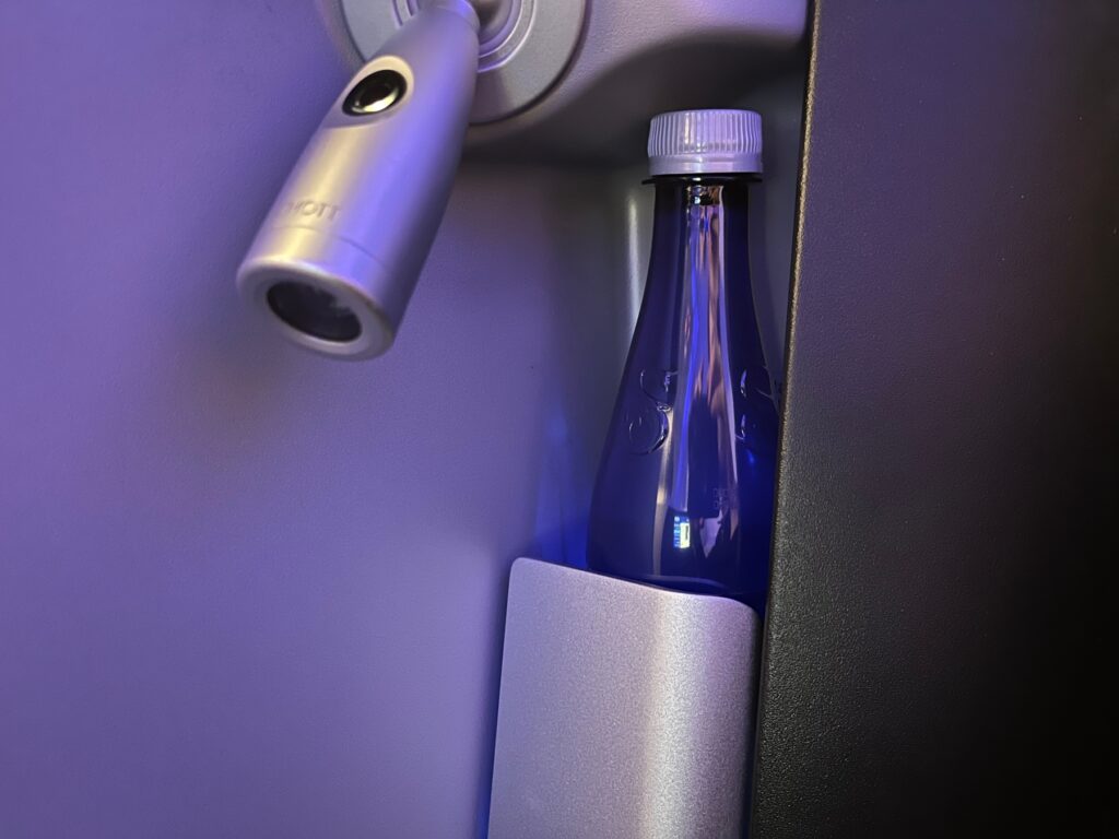 Bottled water by reading light, JetBlue Mint